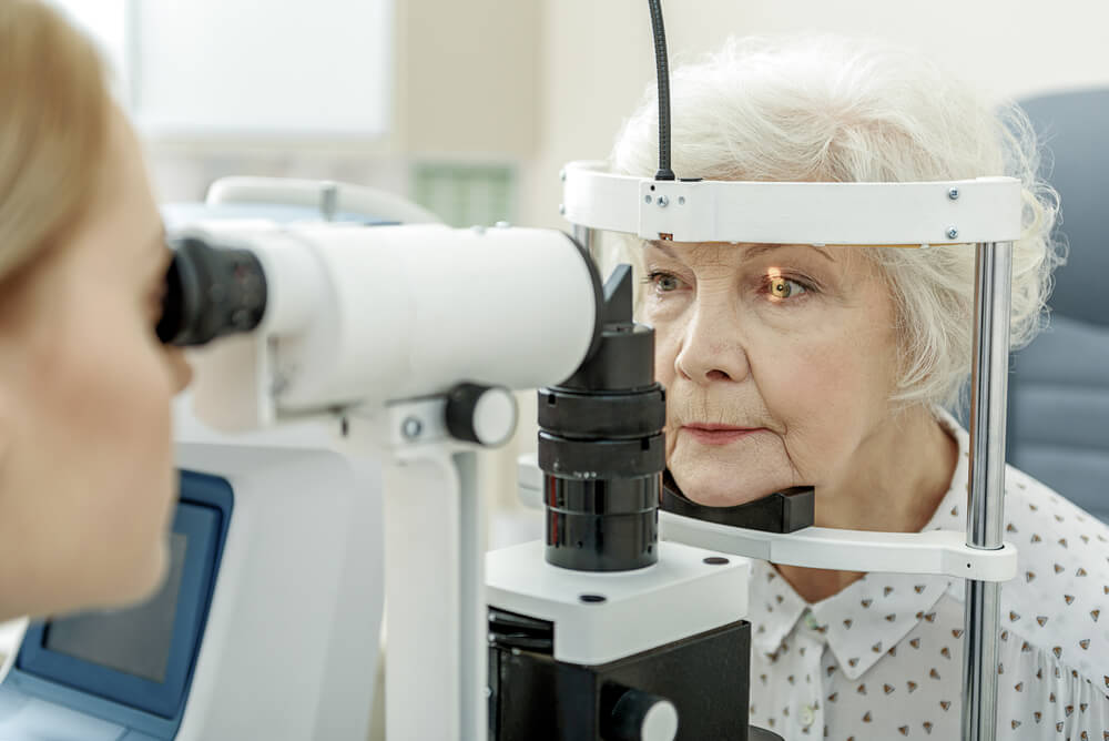 older female getting optometry visit for eye diseases