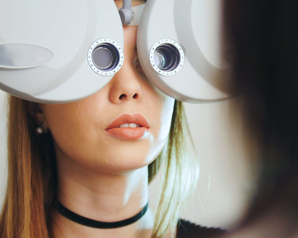 Woman getting an eye exam with optometry equipment