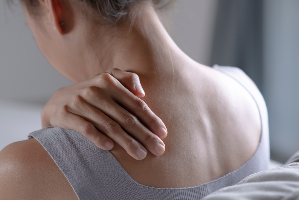 A woman with neck pain possibly dealing with a Spine Tumor