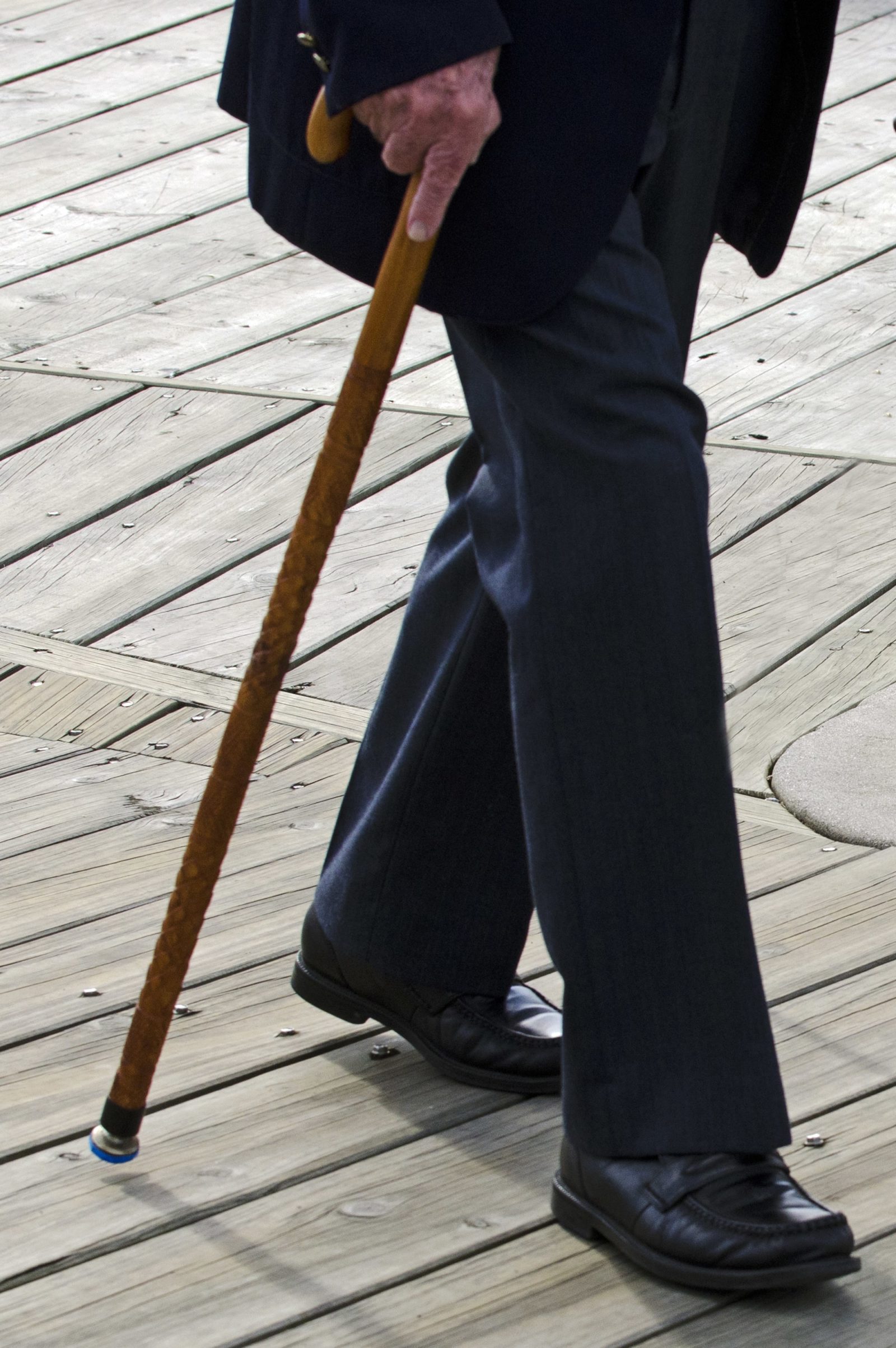 closeup of older man walking with a cane