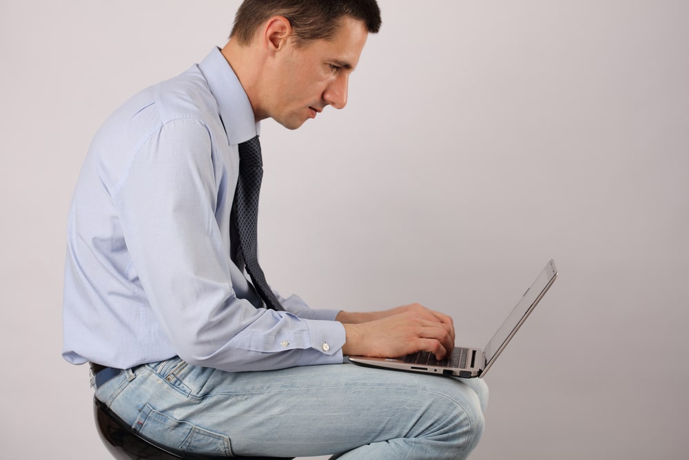 man sitting at computer