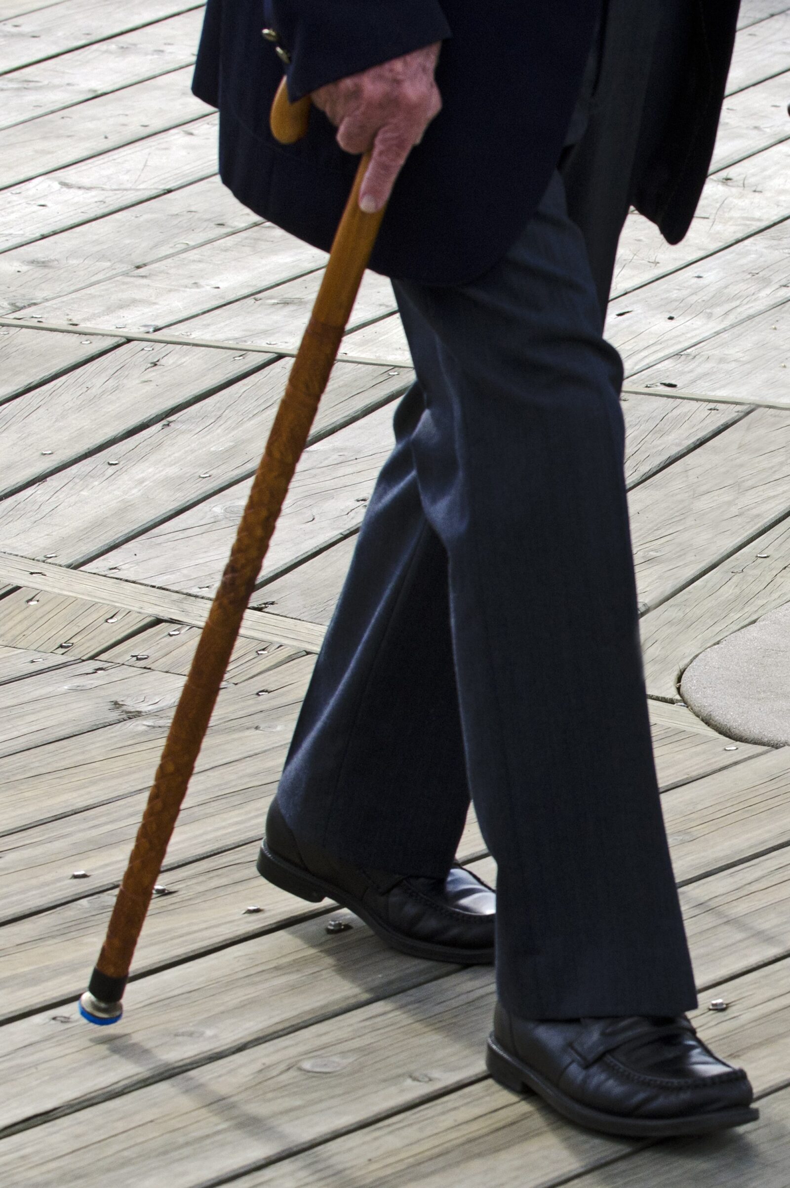 lower half of older man walking with cane