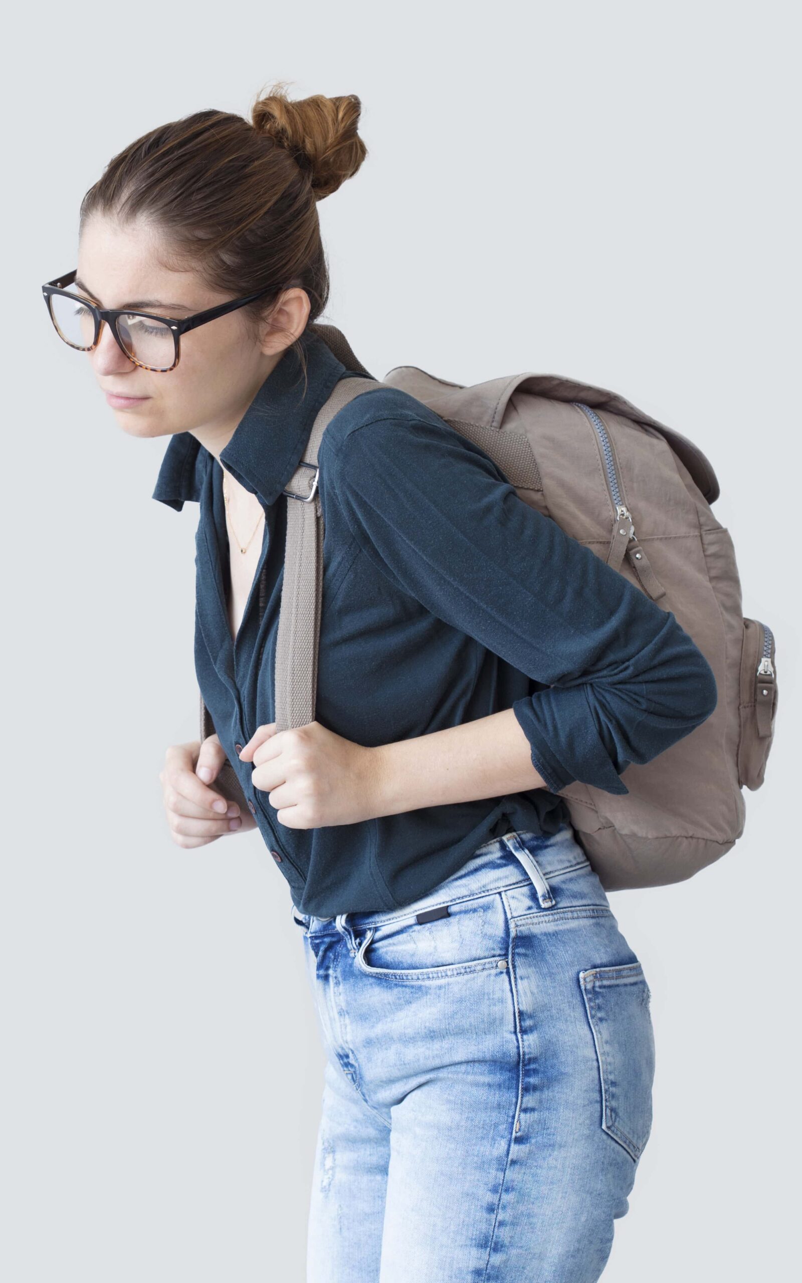 young woman struggling with large backpack