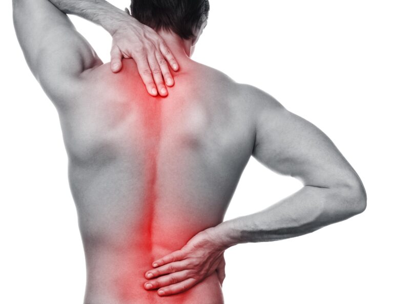 man with back pain. red highlighted on spinal cord