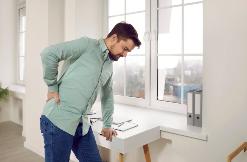 Man,Suffering,From,Backache,In,Ofiice.,Office,Worker