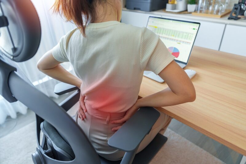 Woman having back body pain during work long time on workplace. due to Piriformis, Low Back, waist ache