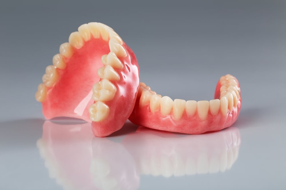 set of complete dentures on isolated background