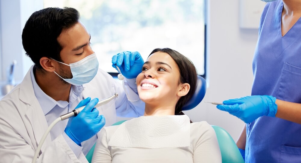 Dentist giving patient tooth filling