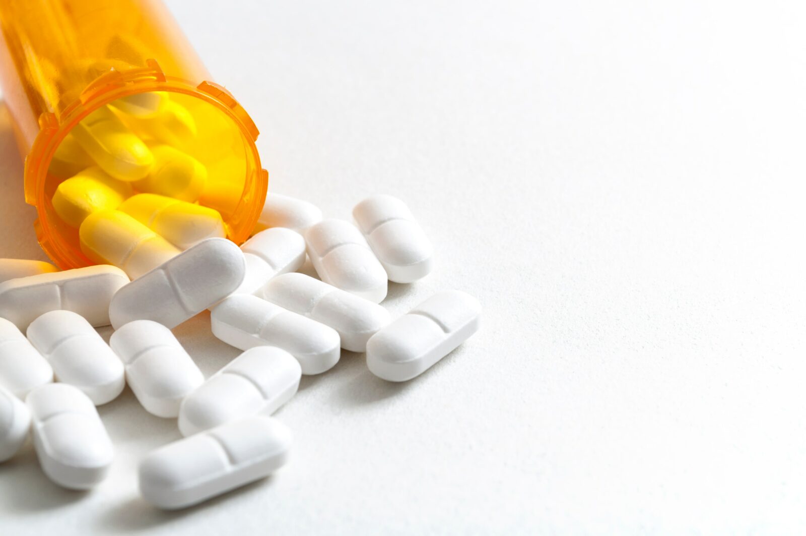 tablets spilling out of prescription bottle