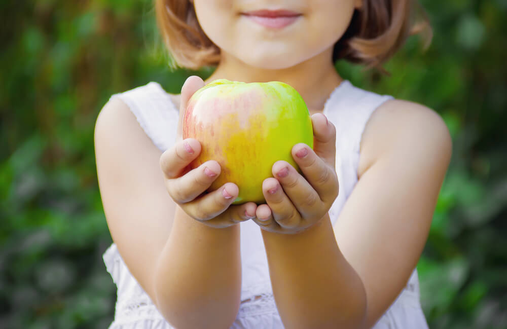 child holding healthy green apple