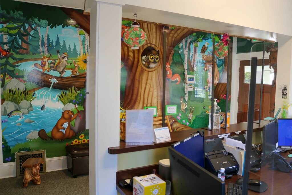 Interior of Silverton office with front desk and mural