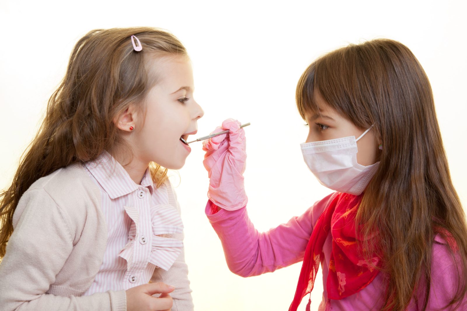 two young girls playing dentist
