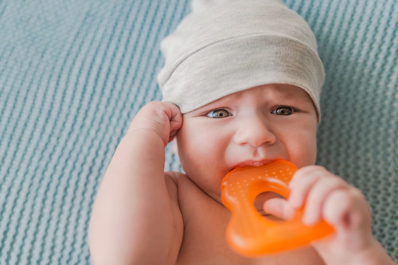 baby chewing on a teething ring