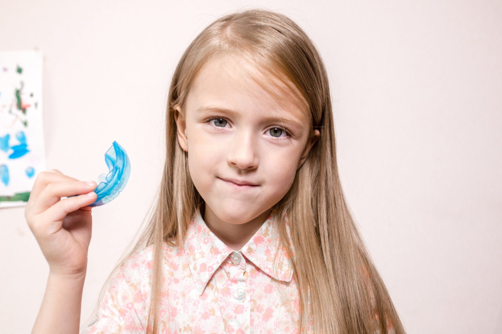 young girl holding up a nightguard