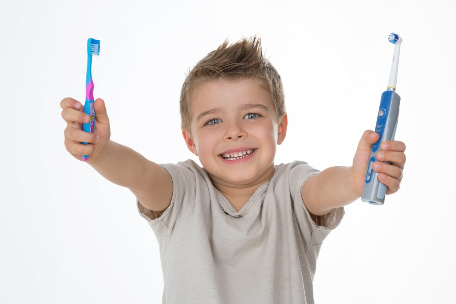 boy holding toothbrushes