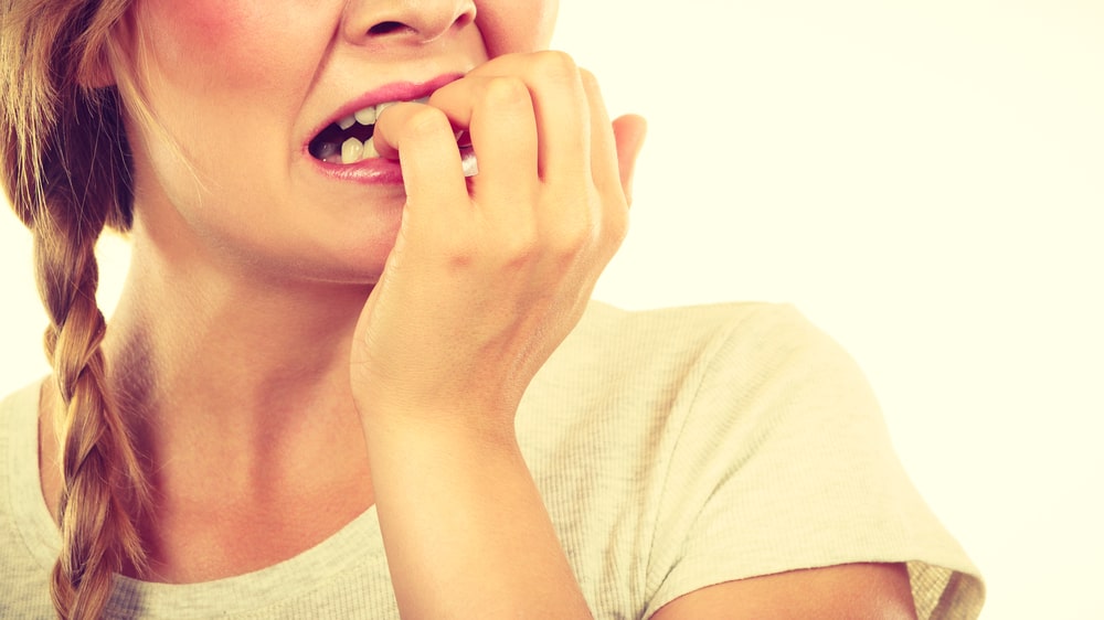 stressed woman biting her nails