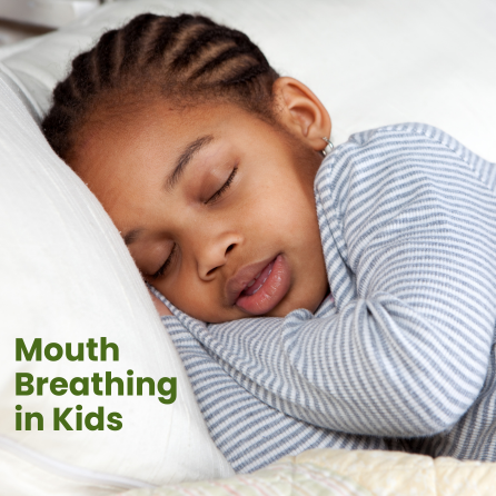 A child sleeps soundly with their mouth open on a pillow.