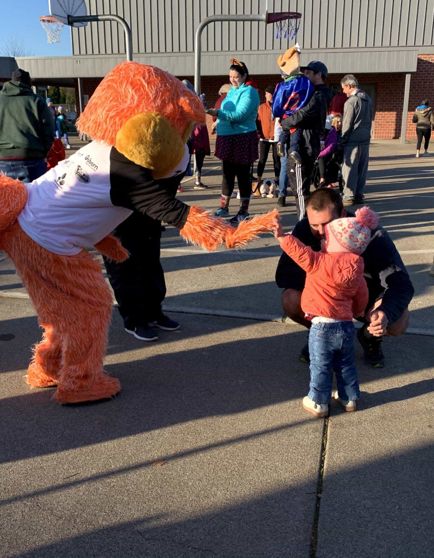 mascot interacting with child at school