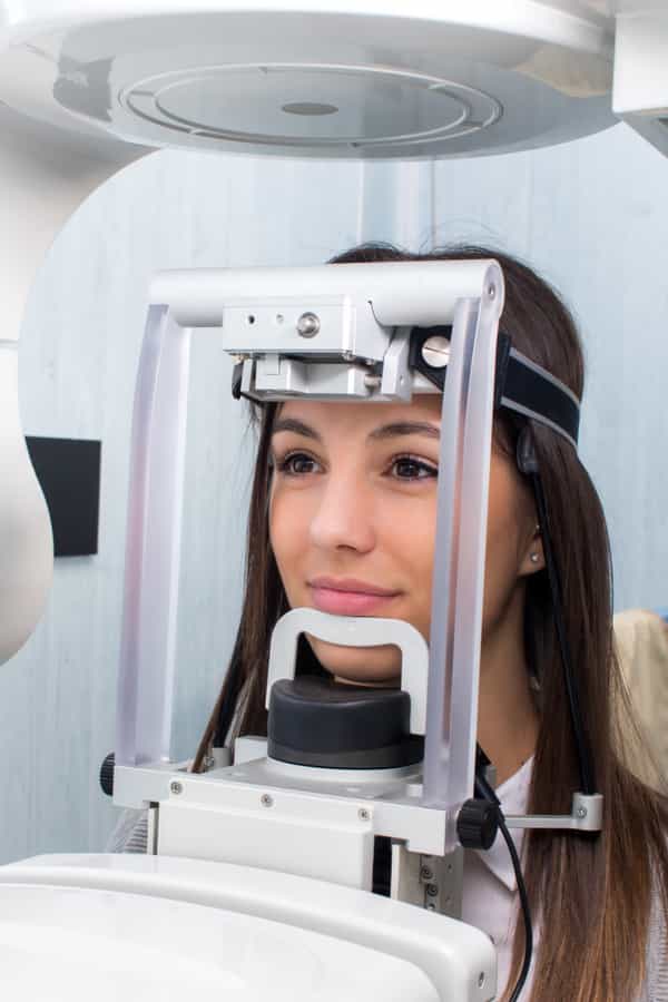 female patient being examined on digital x-ray machine