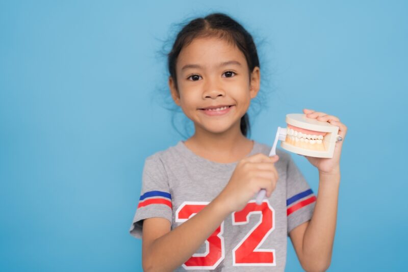 Blog 1 used to demonstrate the concept of Blog Adorable young girl practicing good oral hygiene by brushing teeth