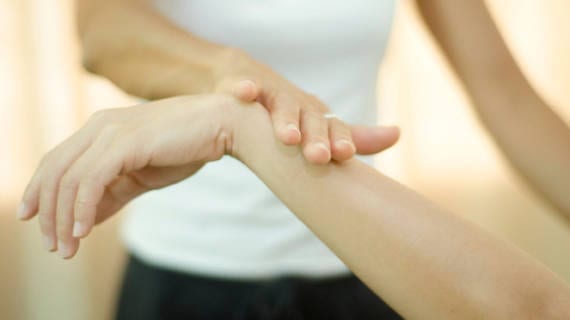 woman touching another persons wrist