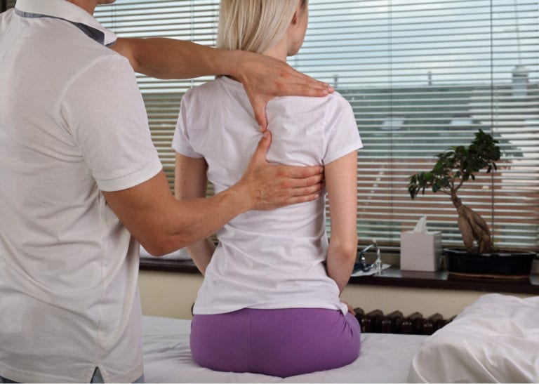 chiropractic care on back of female patient