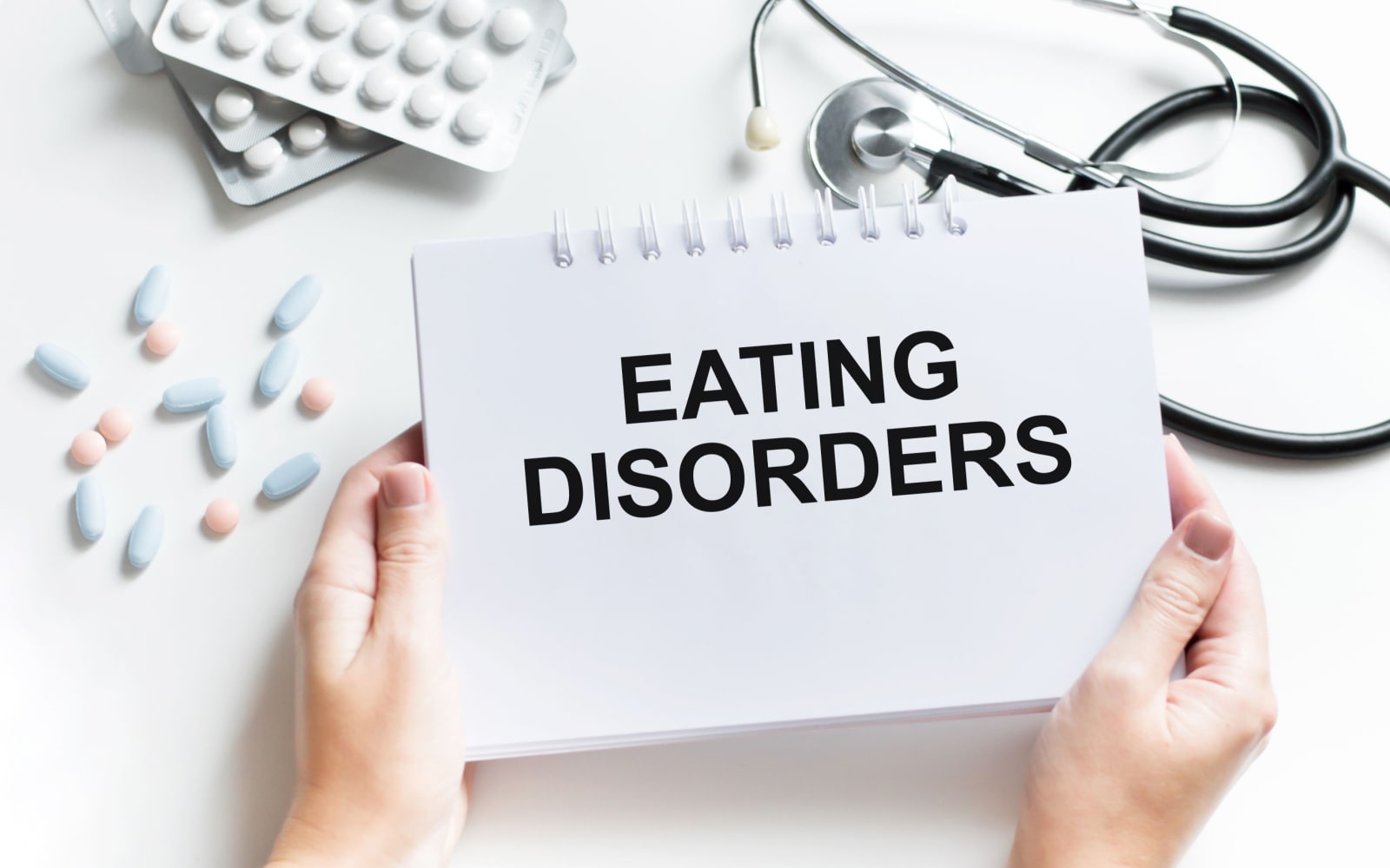 Eating Disorders Text on Notebook with Doctor's Tools