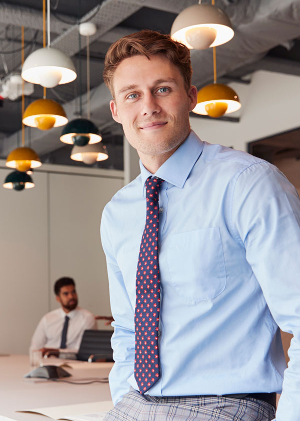 portrait of businessman standing in modern KERTNLY showing the concept of About Us