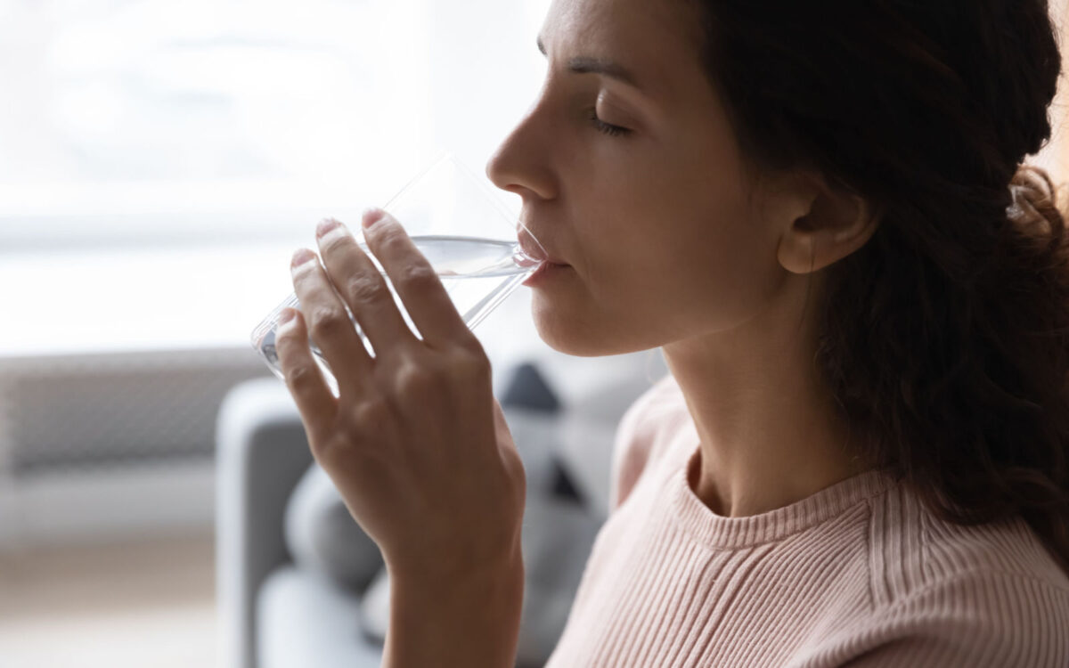 Woman Drinking Water Due to Dry Socket