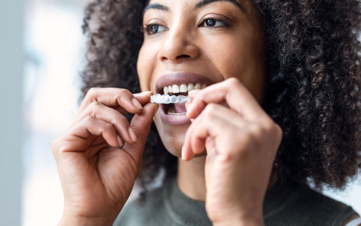 Woman Putting On Invisalign
