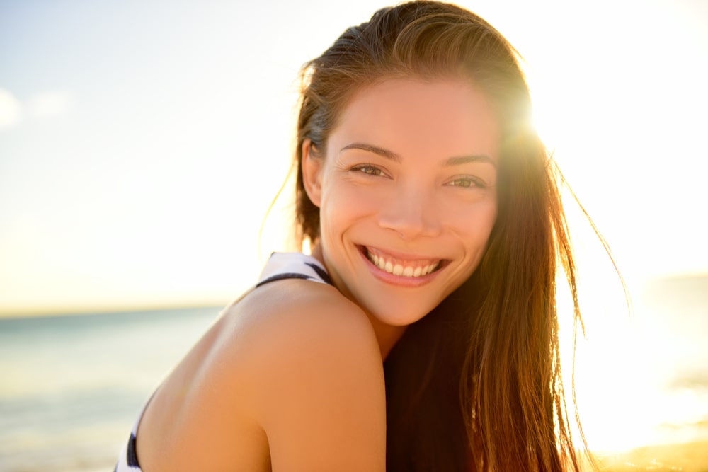 beautiful girl smiling happy on beach vacation