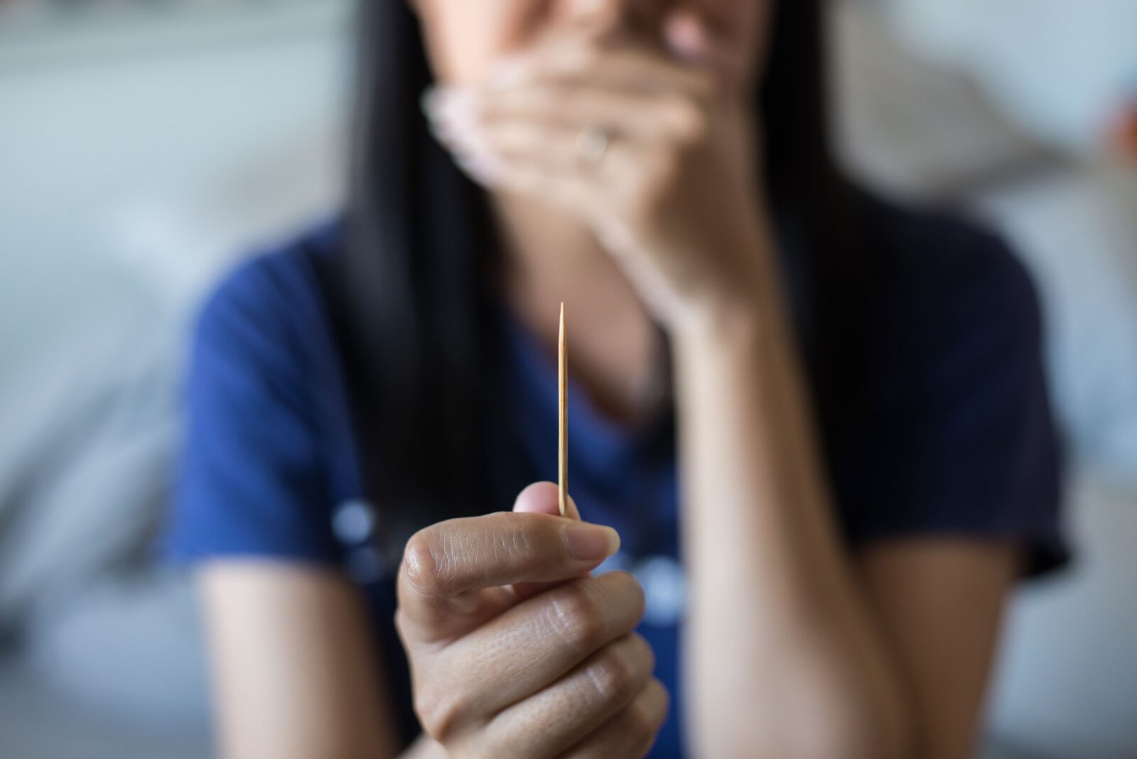 woman holding toothpick