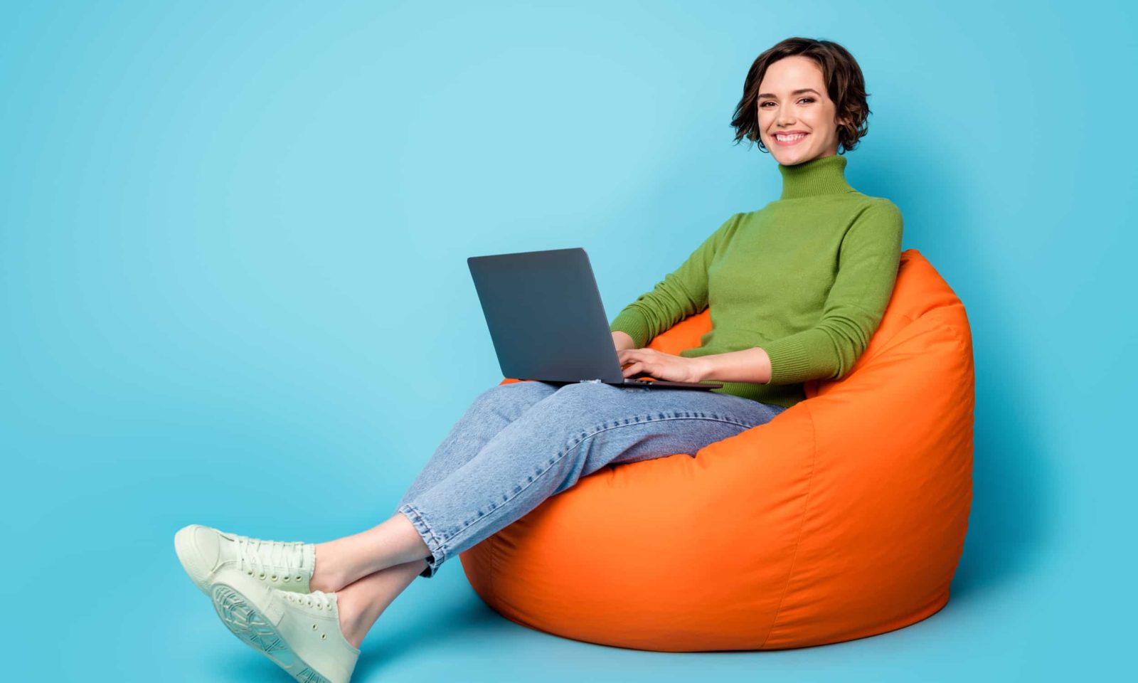 Full length profile side photo of positive girl sit bean chair use laptop enjoy,