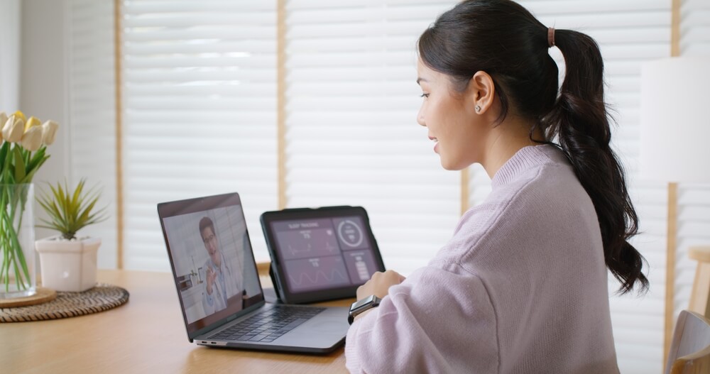 woman is on her laptop talking to her provider