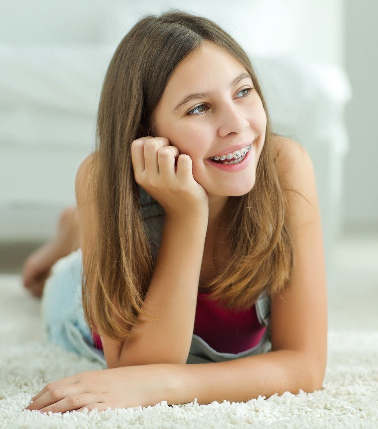 pretty girl having metal braces smiling