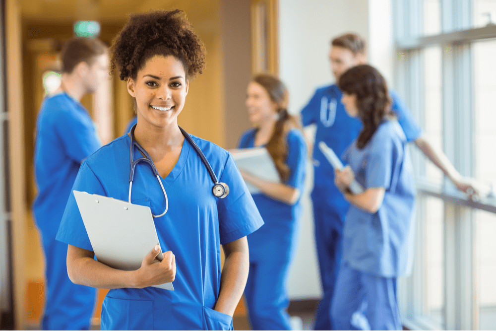 Medical student with curly hair smiling