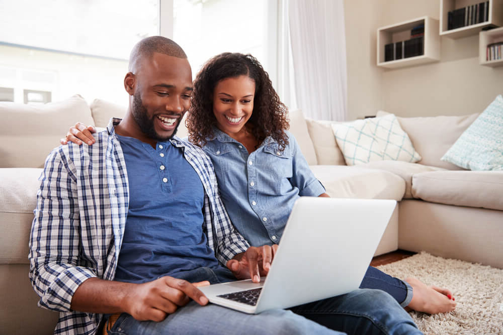 happy couple working on laptop