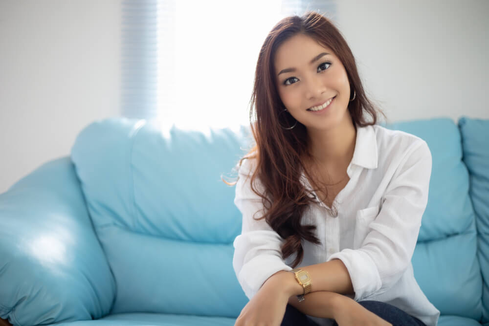 Asian women smiling happy for relaxation on sofa