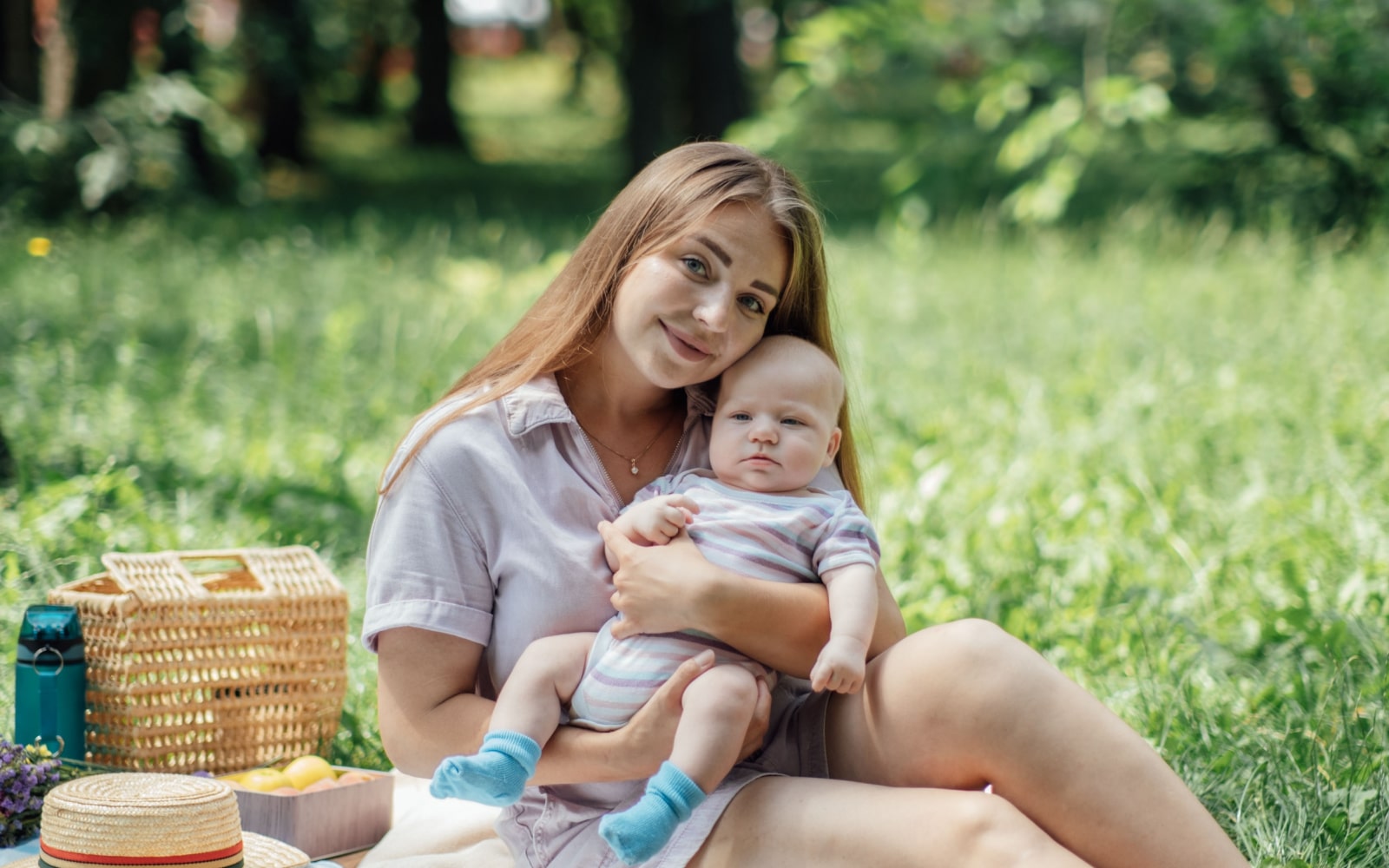 Woman Holding Baby in Park Picnic with Postpartum Depression