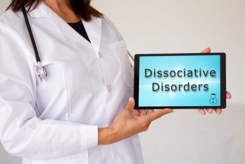 dissociative disorders concept. words written on a woman doctor's digital tablet.