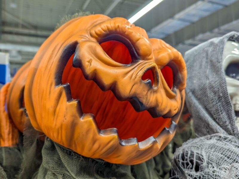 Intricately carved Halloween pumpkin with detailed scary face