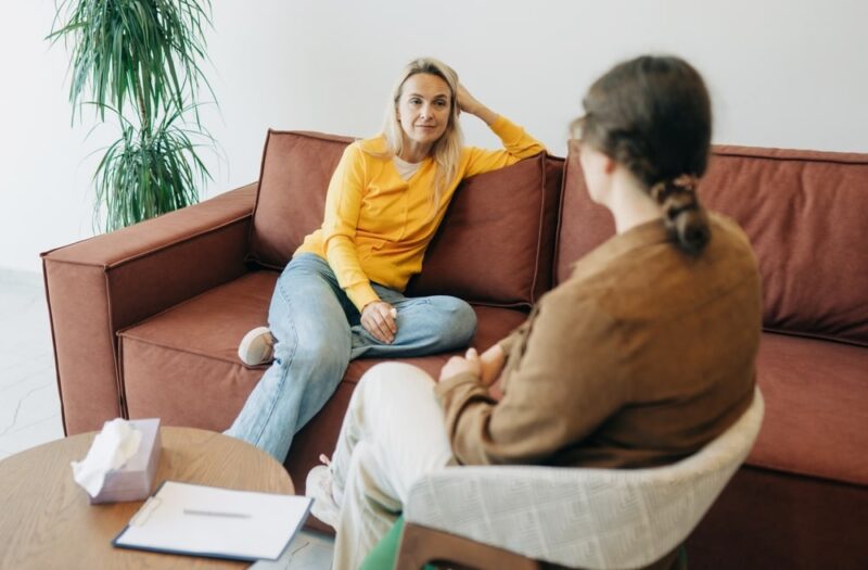 A young woman in a consultation with a professional psychologist listens to advice on improving behavior in life.