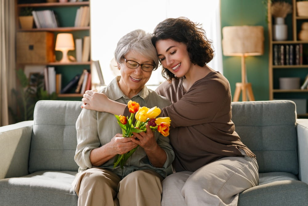 Warm smiles, affectionate embrace, and heartfelt connection highlight authentic family love, intergenerational support, and gratitude.