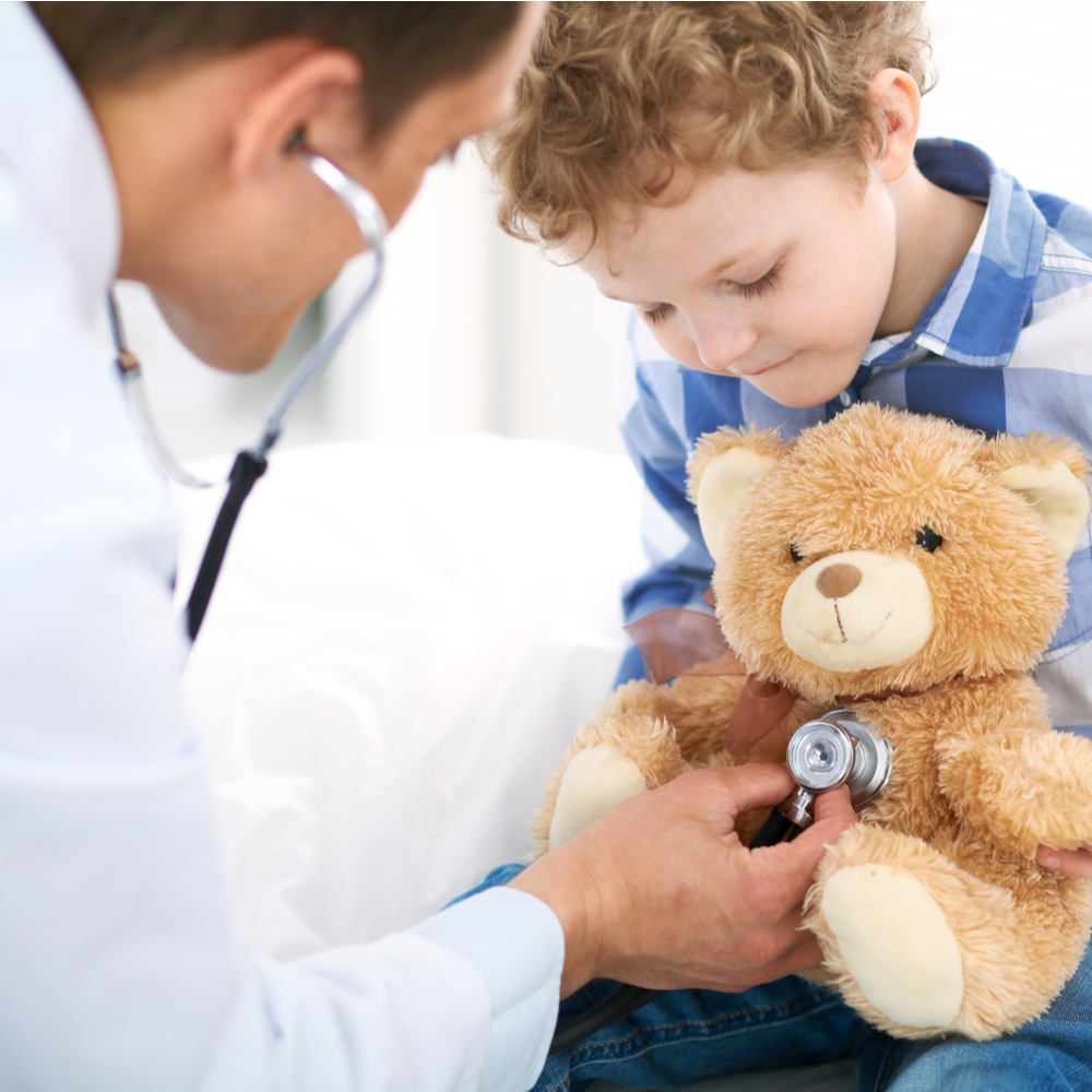 Physician examines little boy by stethoscope