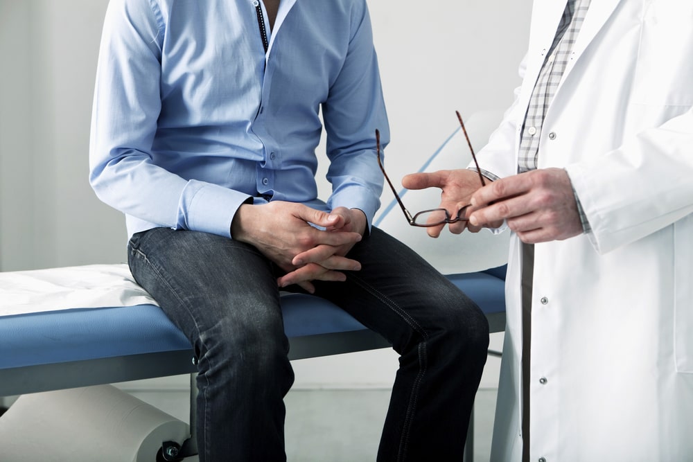 man speaking with doctor