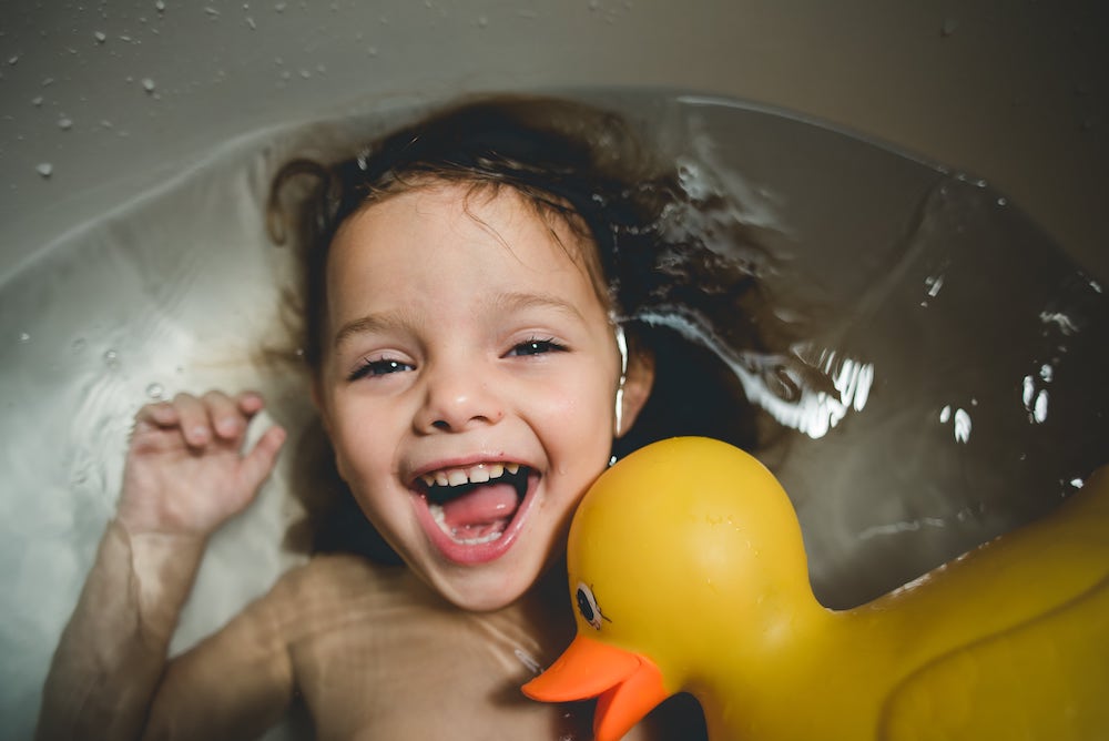 Happy Girl In Tub With Rubber Duck