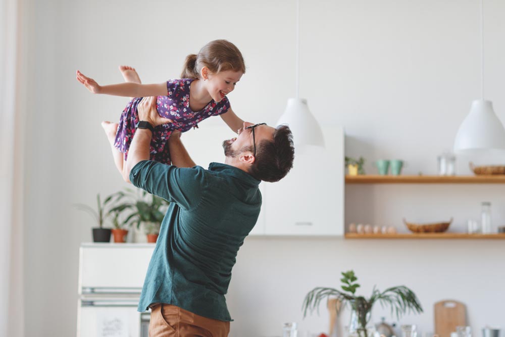 Happy family daughter hugs his dad on holiday