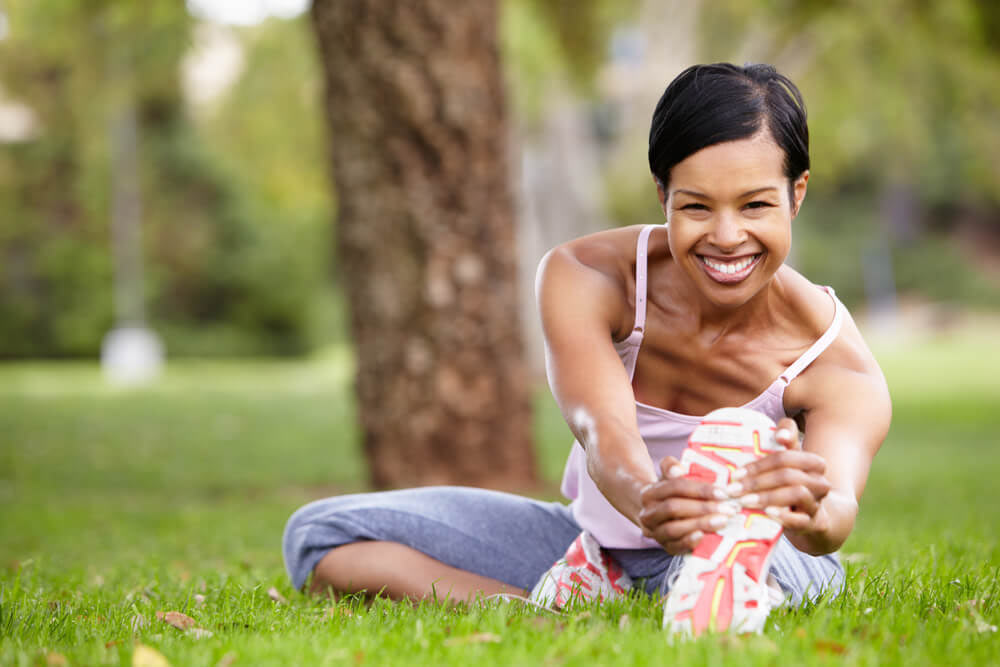 Smiling woman exercising in park