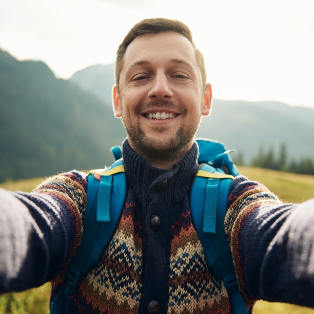 Smiling hiker taking a selfie in the great outdoors