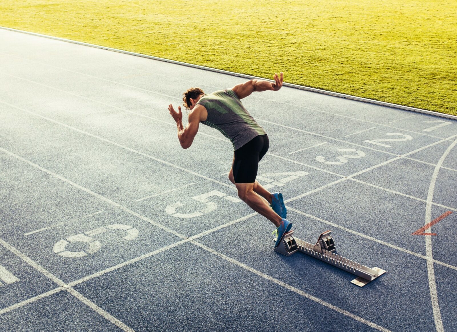 Rear view of an athlete starting his sprint